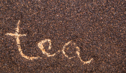Written TEA word on dried tea leaves