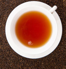 A cup of tea on dried and processed tea leaves