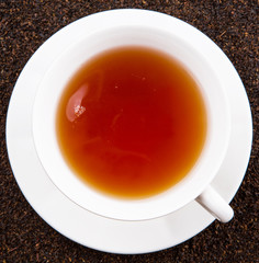A cup of tea on dried and processed tea leaves