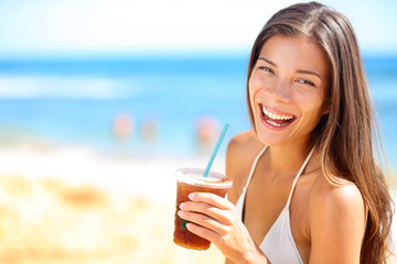 Beach woman drinking cold drink beverage