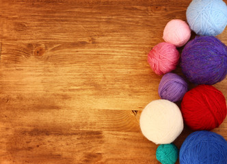 top view of wool balls over wooden table  