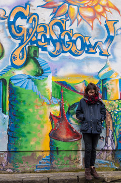 Fototapeta Hipster model standing next to a wall of graffiti in Glasgow