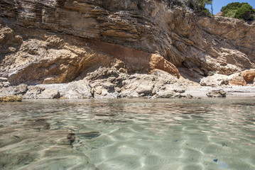 A transparency sea with a rocks as background and some tree