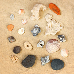Fototapeta na wymiar top view of collection of beach stones rock and shells over sand