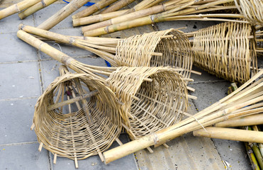 Bamboo wickerwork basket on floor near black soil