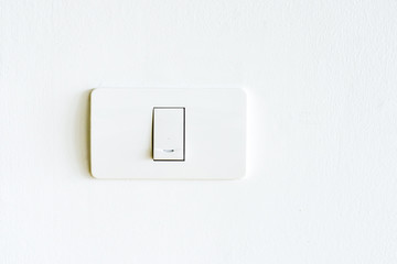 Lighting switch on white wall