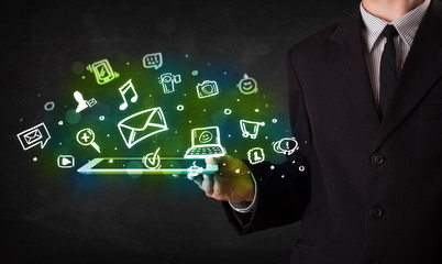 Obraz premium Person holding a tablet with media icons and symbols