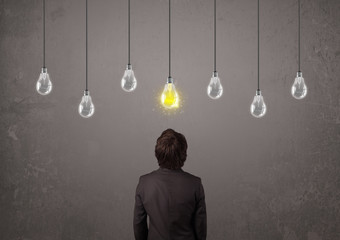 Businness guy in front of idea light bulbs concept