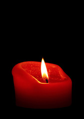 Red candle in dark