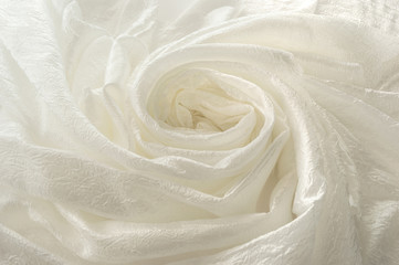 Shiny white cloth folded in the shape of a spiral
