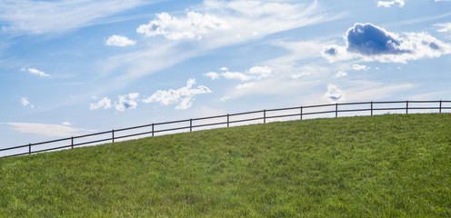 Fototapeta na wymiar Fence along a slope