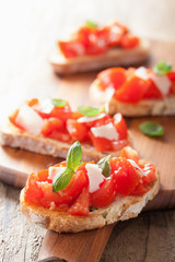 Italian bruschetta with tomatoes, parmesan, garlic and olive oil