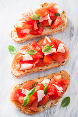 Italian bruschetta with tomatoes, parmesan, garlic and olive oil