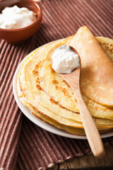 stack of pancakes with sour cream
