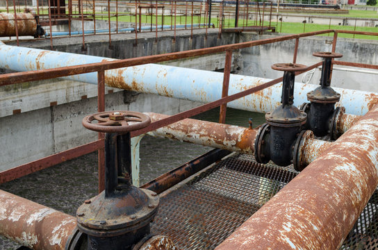 Rusty big tap and pipes and water treatment liquid