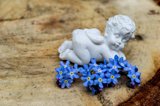 porcelain angel figurine and blue flowers