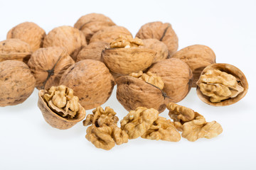 walnut and a cracked walnut isolated on the white background