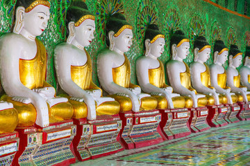 Buddhas and wall in temple, Sagaing hill, Mandalay, Myanmar