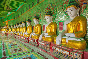 Buddhas and wall in temple, Sagaing hill, Mandalay, Myanmar