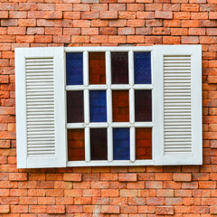 white window on red brick wall