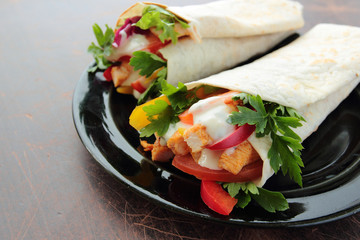 Tasty tortilla wraps with chicken and fresh vegetables
