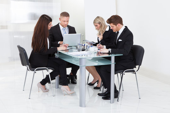 Businesspeople Working At Desk