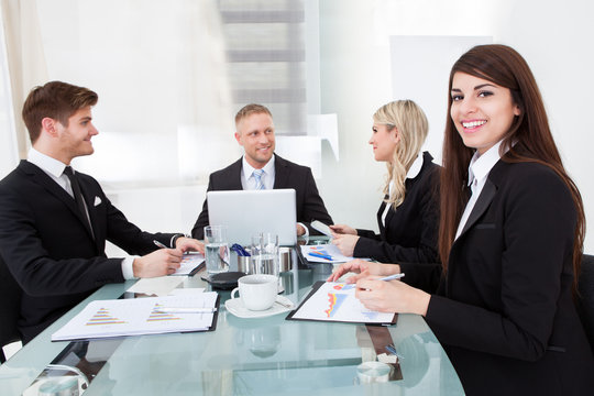 Businesswoman Sitting With Colleagues In Meeting