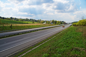 Spring country landscape with a highway