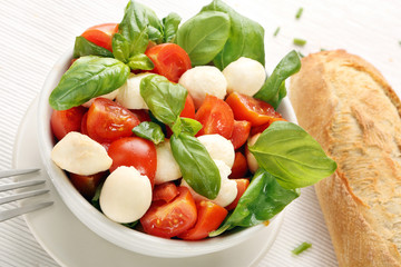 Caprese salad. Tomato and mozzarella with basil.