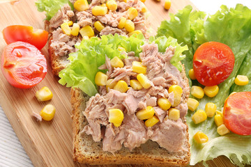 Sandwich with tuna and corn on wood background © wideonet