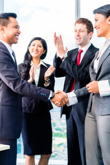 Asian Businesspeople shaking hands