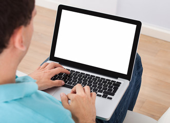 Man Using Laptop At Home