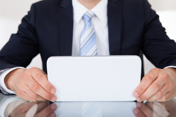 Businessman Using Digital Tablet At Desk