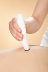 Woman Receiving Microdermabrasion Therapy At Spa