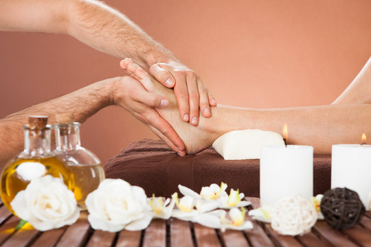 Therapist Massaging Customer's Foot At Beauty Spa