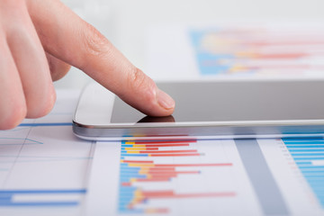 Businessman Analyzing Bargraph At Desk