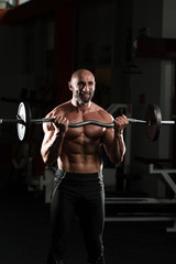 Obraz na płótnie Canvas Healthy Man Working Out Biceps In A Health Club