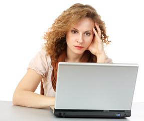 A tired woman in front of a laptop