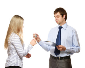 A male realtor giving keys to a woman