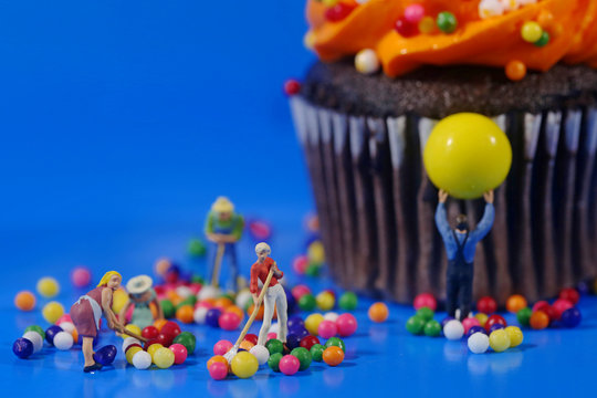 Plastic People Cleaning Up a Messy Cupcake