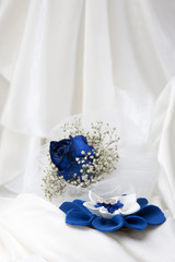 a  blue roses and wedding rings