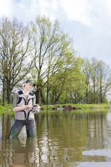 Fototapeta na wymiar woman fishing in pond in spring