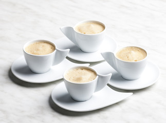 four cups of coffee with milk