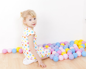 little girl playing with balls