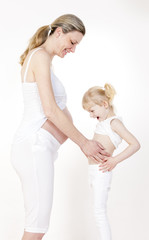 little girl with her pregnant mother