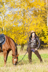 equestrian with her horse in autumnal nature