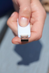 hand holding black USB data storage