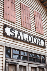 Saloon sign on western wooden building
