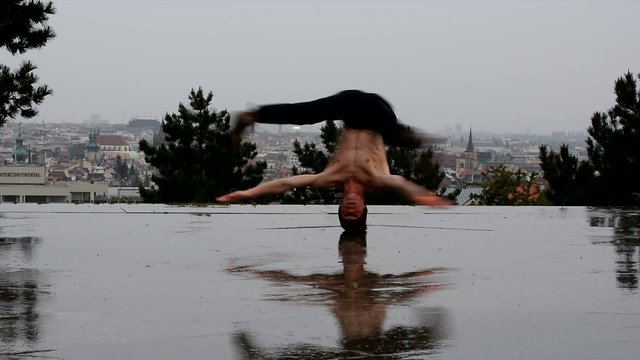 The boy turns his head in the rain in Prague