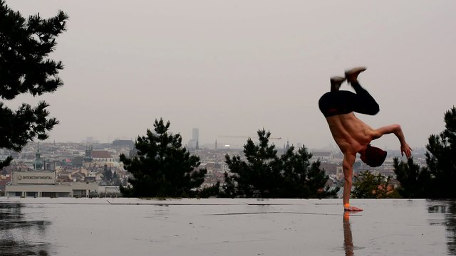 Breakdancer dancing breakdance in the rain in Prague